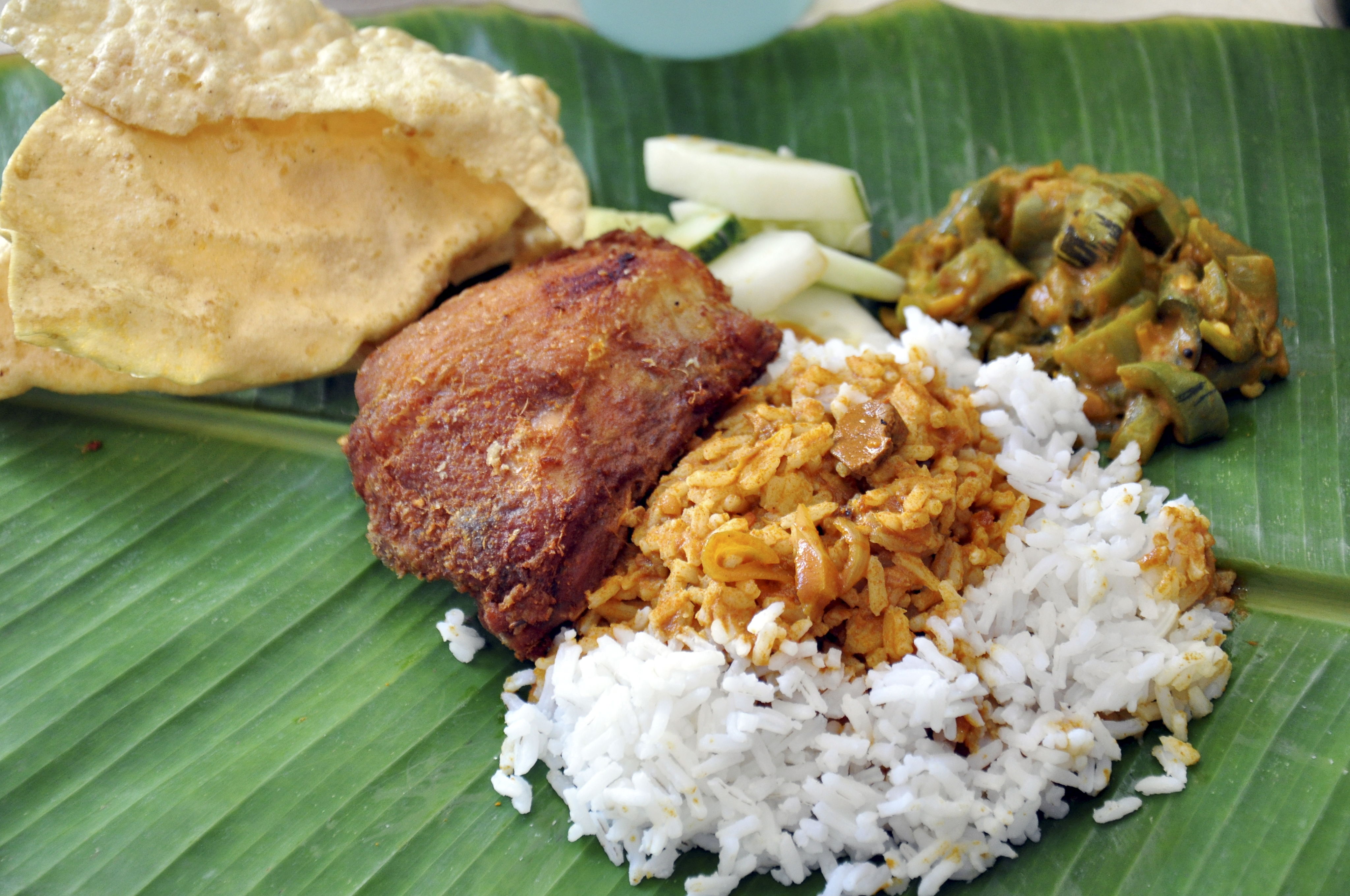 The banana leaf meal at Yap Kee Coffee Shop is served with vegetable of the day cucumber and papadam along with your choice of chicken fish or mutton.