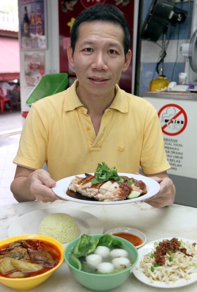 Danny Koh with his famous Tim Kee chicken rice. The chicken is roasted the traditional way in a charcoal oven.