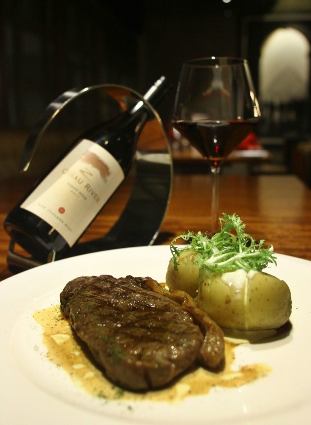 The Grilled Black Angus Sirloin with Baked Potato and Sour Cream is paired with Pinot Noir, 2009 from New Zealand.
