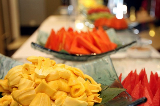 A selection of local fruits are available at the buffet spread.