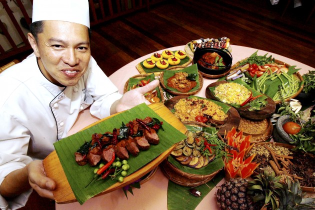 Avillion Port Dickson executive chef Chan with the fusion dishes he concocted for the hotel's buka puasa buffet.