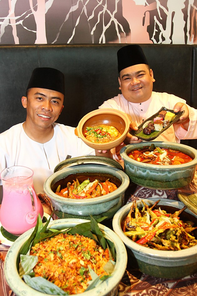 Chef Hashrul (left) and chef Farez showing off some of the sumptuous finds on buffet line at Vasco's this Ramadan.