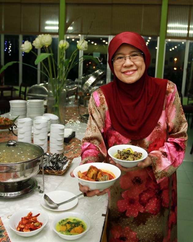 Habsah Hassan, the owner of Puteri Penchala Restaurant, showing off the two Malay dishes available at the outlet.
