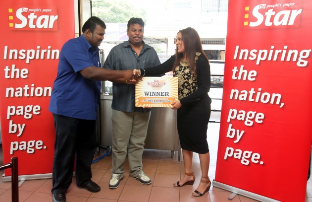 Esther (right) presenting a mock recognition certificate to Yoges (left) and Thelaganathan.