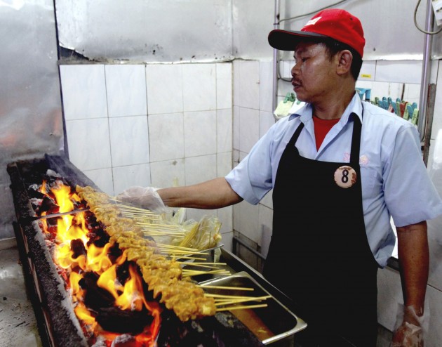 A Sate Kajang Hj Samuri worker at the old Medan Sate shop in Jalan Sulaiman, Kajang, grilling the much-loved satay.