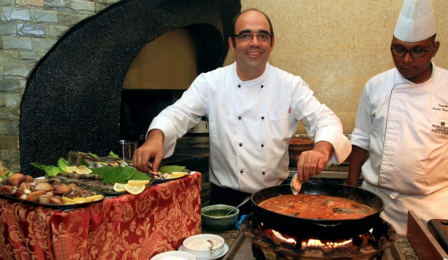 Chef Jordi Gimeno (left) preparing Black Rice, Sea and Mountain Paella to be served fresh to diners.