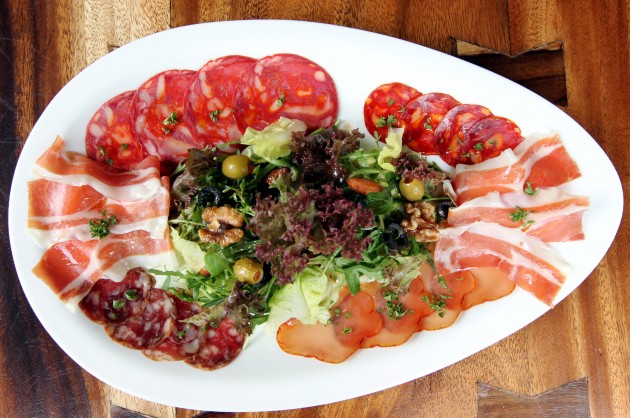 The NBDD Platter, a combination of  Serrano ham, lomo (cured pork tenderloin)  and a selection of chorizo slices with  garden greens with balsamic vinegar,  walnut, almonds and olives.
