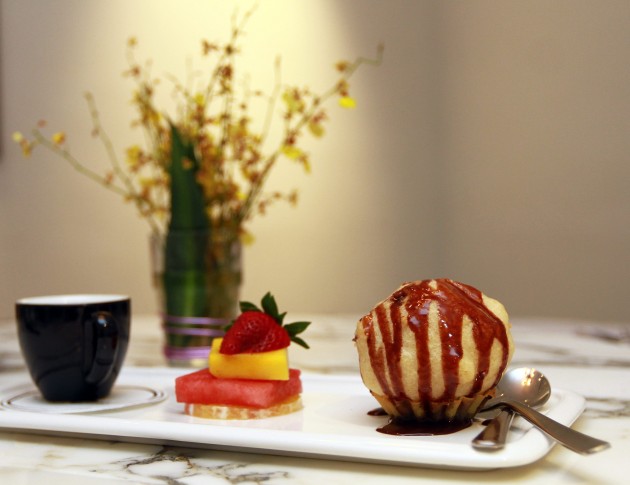The trio of desserts comprises flat white coffee, fruit slices and fried ice cream.