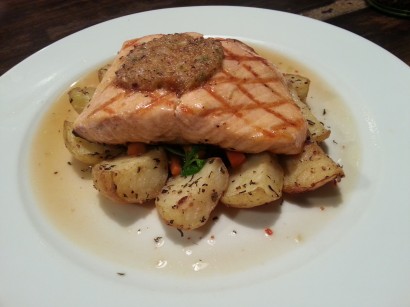 The Salmon Oreganato is served over sauteed spinach, peppers and zucchini with rosemary potatoes, making it a wholesome meal.