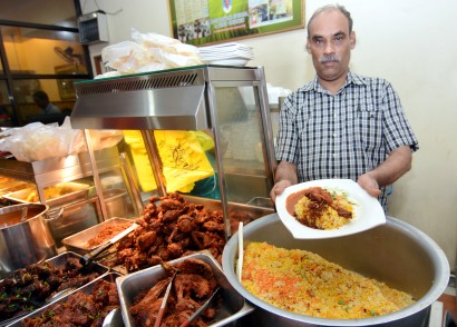 Top seller Thajudeen with Restoran Tajudin Nasi Briani’s best-seller, nasi briyani with fried chicken.