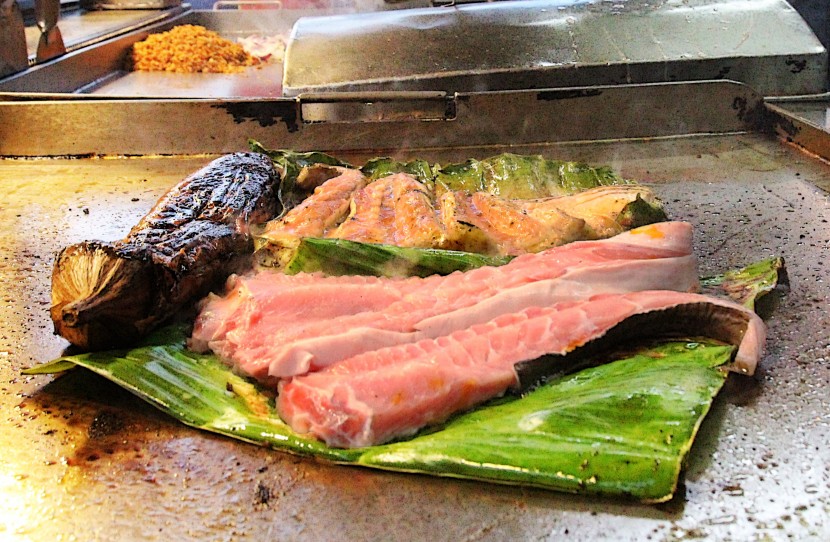 Juicy fish: Two sides of stingray grilling beside a large brinjal at Teh Yoon Peng's grilled fish stall.