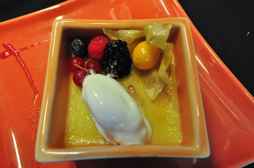 Warm apricot clafoutis served with coconut ice cream and fresh berries. 