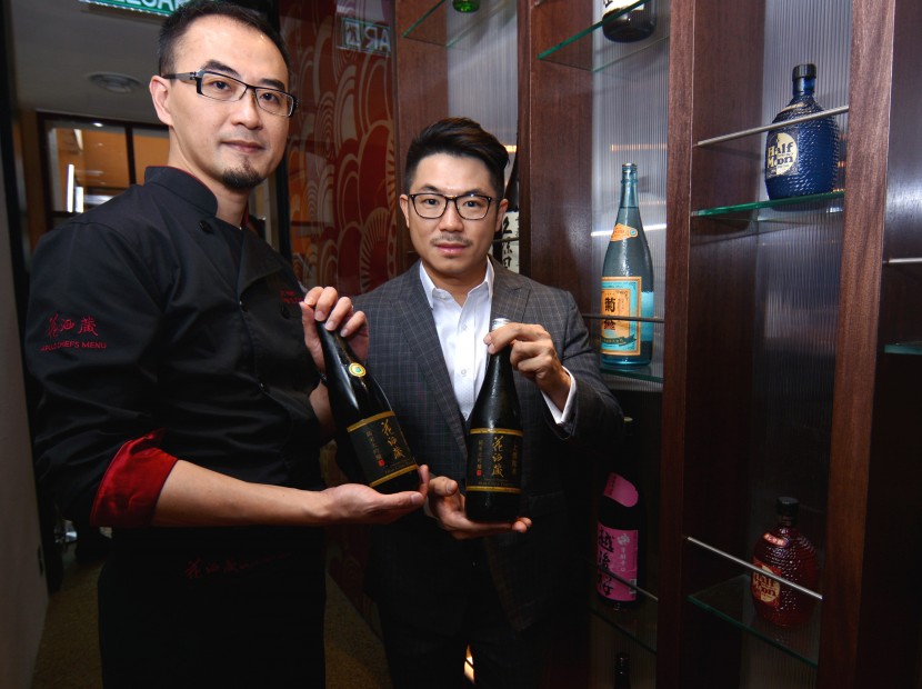 Hana Dining Sake Bar Sdn Bhd CEO Eddie Beh (right) and Aplus Dining Sake Bar Eric Hsieh showing their exclusively branded sake bottle, during the restaurant's grand opening ceremony. 