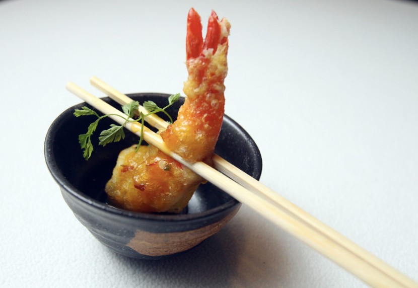 Spiced Tempura Prawns, Passion Fruit and Chilli Coulis, with the tempura prawn wrapped in sweet, slightly tangy sauce.