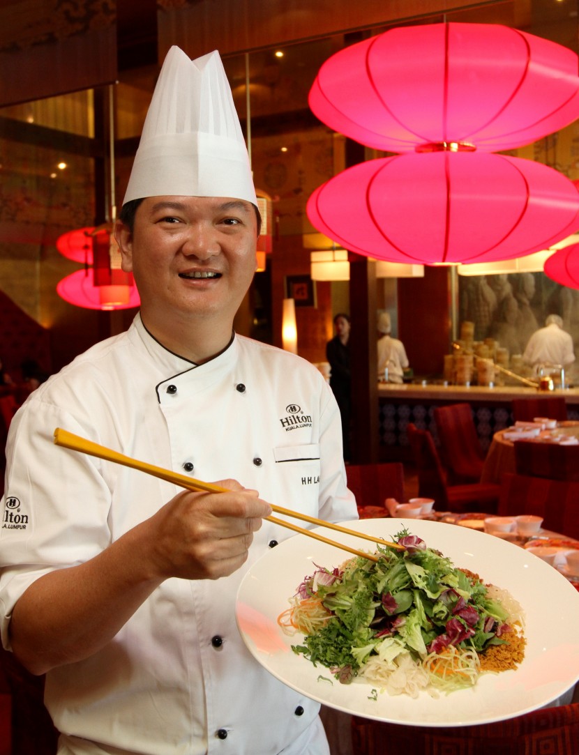 Hilton Kuala Lumpur executive Chinese chef Lam Hock Hin with the Mixed Salad with Squid Tentacles and Coconut White Curry. 