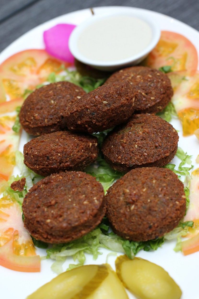 The falafel is fried beans and chickpea paste shaped into a ball, that is served with tahini sauce. 