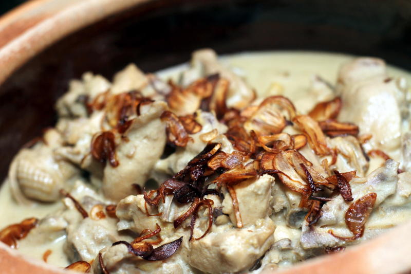 Opor Ayam is chicken cooked in coconut milk with galangal, lemongrass, cinnamon and other spices.