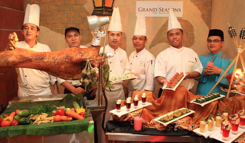 Chef Fauzi (far left) with his brigade and their offering this fasting month, ranging from spit-roasted mutton (left), to a whole range of mouthwatering desserts both Western and local.