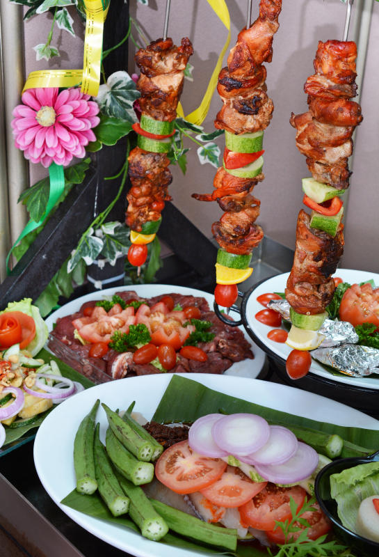 Savour grilled items like Tandoori Chicken Kebabs (top), Curry Marinated Lamb Chops (middle left), Portuguese Fish in Foil (middle right), and Daging Lada Hitam (bottom).