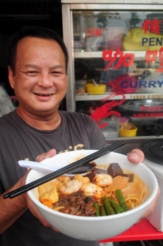 Tan serves a taste of Penang-style curry noodles at the Sun Sea Restaurant in Taman OUG.