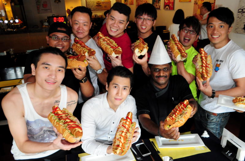 Euro Deli owner Santa Boon (2nd from left) and head chef Gunalan Ramadass with participants of the 12-inch Wiener Speed Eating Contest.