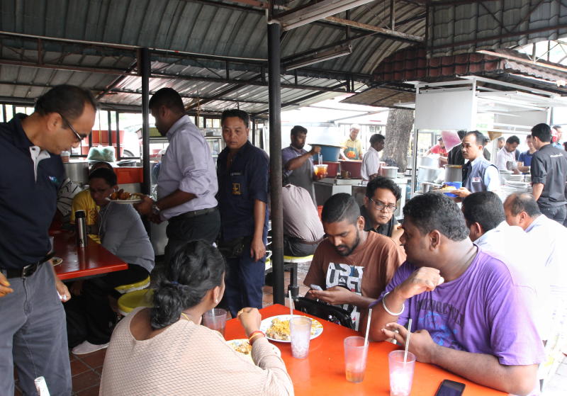 From corporate heads to despatch boys, Anuar's Fish Head Curry stall draws in a variety of customers.